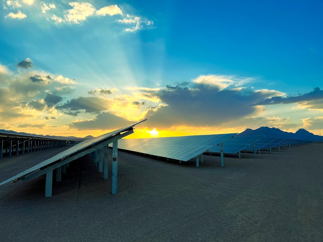a-row-of-solar-panels-sitting-on-top-of-a-sandy-beach-iopyz4hdcnq