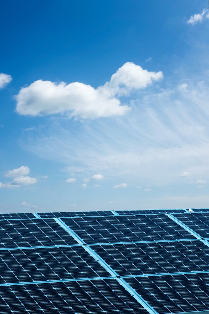 Solar panels under a clear blue sky, symbolizing renewable energy and sustainability.
